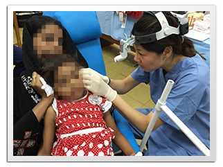 Removing wax from a child' s ears, Hambantota 2015