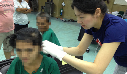Dr Annabelle examining a child’s ear at the Thailand ear camp