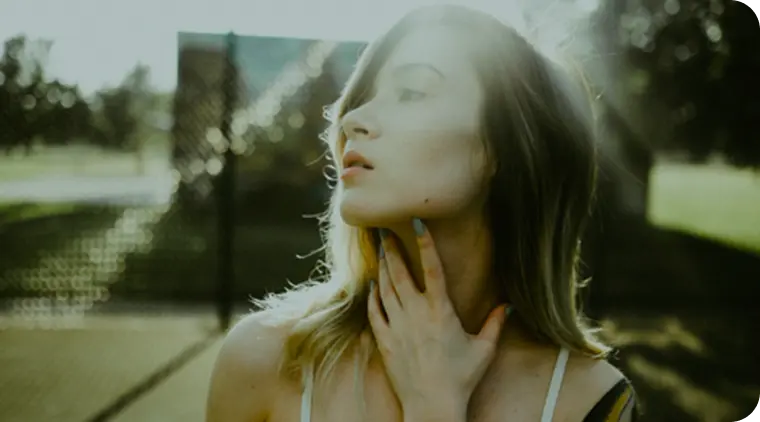 woman touching her throat